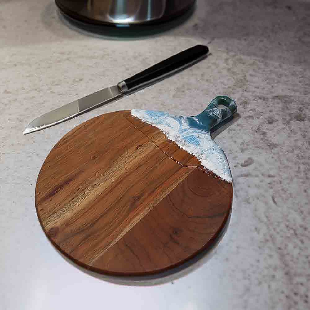 Ocean themed cheese board on kitchen counter.