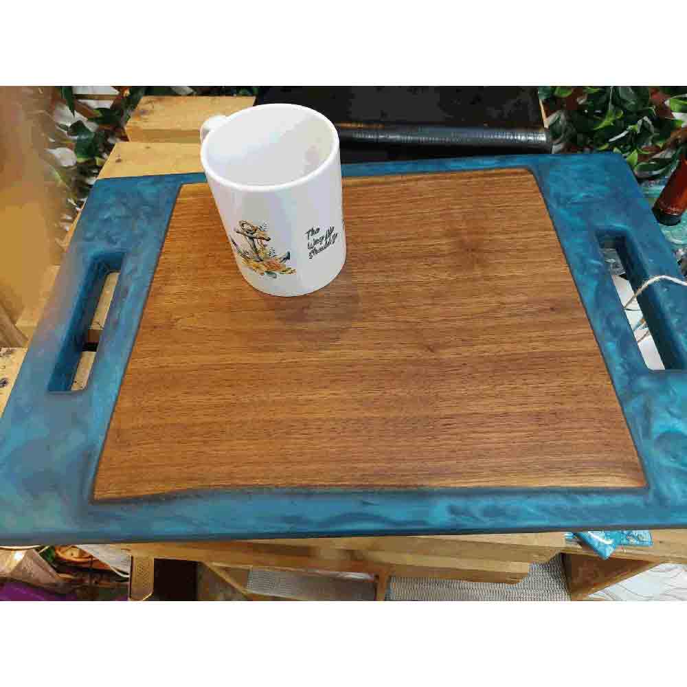 Black walnut cutting board with resin handles.