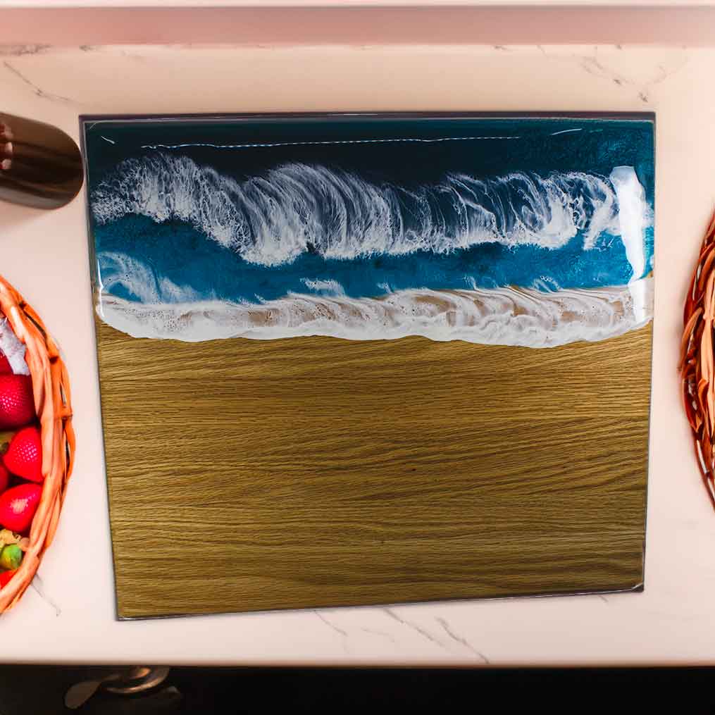 Ocean resin painting on an oak cutting, charcuterie board.