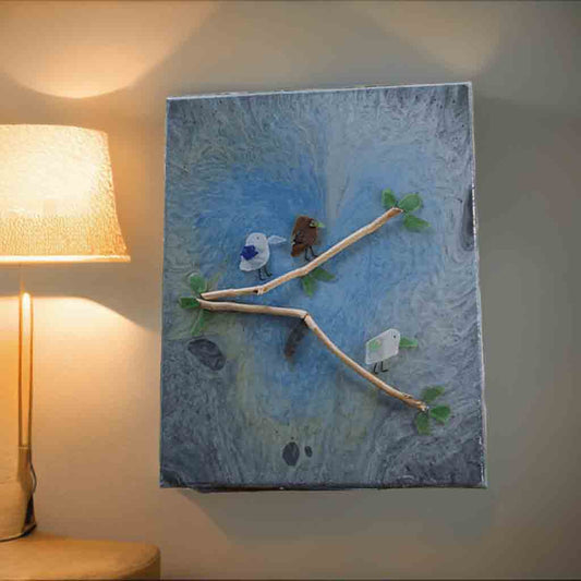 Abstract acrylic painting with a heart in the center, sealed in resin and birds made out of sea glass perched on driftwood twigs.